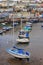 BRIXHAM, DEVON, UK, NOV 02 2015: Small boats moored at low tide in the fishing port, with the town of Brixham in the background