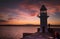 Brixham lighthouse with an orange dusk sky