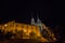 Brno Cathedral of saints peter and paul, seen from the bottow of Petro Hill, at night, surrounded by darkness.