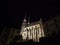 Brno Cathedral of saints peter and paul, seen from the bottow of Petrov Hill, at night, surrounded by darkness.