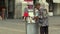 BRNO, CZECH REPUBLIC, AUGUST 11, 2017: Authentic homeless poor man looking and eats food from the trash bin, town Brno