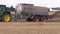 BRNO, CZECH REPUBLIC, SEPTEMBER 17, 2017: Tractor John Deere special trailer spreading fertilizer of slurry on field