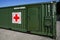 Brno, Czechia - October 08, 2021: Green metal army container box - Surgical module - with red cross, setup as field ambulance