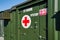Brno, Czechia - October 08, 2021: Green metal army container boxes with red cross, setup as field ambulance demonstration during