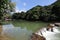 A broad dam spans across the river