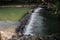 A broad dam spans across the river