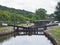 Broadbottom lock on the rochdale canal on the outskirts of mytholmroyd west yorkshire with summer trees lining the valley