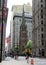 Broadway in downtown Financial District, steeple of the Trinity Church in the center, New York, NY