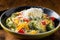 Broccoli and bell peppers in a creamy rice dish topped with grated cheese