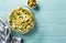 Broccoli, cauliflower, green olives and cheese homemde casserole on blue wooden table