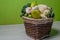 Broccoli and cauliflower with sweet peppers and porcini mushrooms. Wicker brown basket with green vegetables