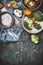 Broccoli , champignons mushroom and other vegetarian cooking ingredients with kitchen knife on dark rustic background, top view