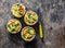 Broccoli cheddar mini savory pies on wooden background, top view. Delicious appetizers, snack, tapas. Flat lay
