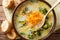 Broccoli cheese soup served with toasted bread close-up in a bow