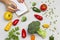 Broccoli, colorful peppers and pumpkin seeds. Hands write on sheet of clipboard