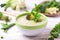 Broccoli and green peas puree soup decorated with mint