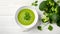 Broccoli green soup with fresh parsley. Healthy and diet vegan dish. Top view on stone table