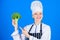 Broccoli has impressive nutritional profile. Woman chef hold broccoli vegetable. Healthy vegetarian recipes. Healthy