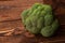 Broccoli isolated. On a wooden background. Top view. Free space for your text. Close up green plant ingredient, raw