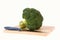 broccoli with knife on cutting board isolated