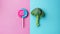 Broccoli and lollipop on a blue-pink split background. Healthy versus junk food. Diet concept. Generative AI