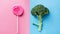 Broccoli and lollipop on a blue-pink split background. Healthy versus junk food. Diet concept. Generative AI