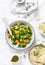 Broccoli, pumpkin warm salad with couscous on a light background, top view. Vegetarian food concept, healthy diet lifestyle