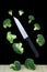 Broccoli slices and knife floating