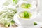 Broccoli soup in bowls on wooden kitchen table closeup. Healthy vegetarian dish