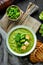 Broccoli, spinach cream soup in a bowl with toasted bread. Green soup. Dietary food.