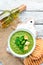 Broccoli, spinach cream soup in a bowl with toasted bread. Green soup. Dietary food.