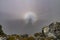 Brocken specter seen from the top of a mountain.