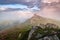 Brocken Spectre in the meadow among the highest mountains , fog and dramatic sky. Beautiful summer scenery. The rhododendron