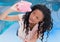 Broke black woman looking on piggy-bank . empty pocket concept. blue and lights background