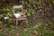 Broken and abandoned chair in the woods