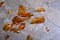 Broken amber vase shards on floor