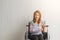 Broken arm woman with arm sling sponsored in her hands sitting on a wheelchair Ideas for accident Injuries and health care
