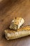 Broken baguette on a wooden background. Macro photography of a baguette