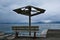 Broken Beach Umbrella and Park Bench on an Overcast Day, Greece