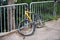 Broken bike attached to a street fence