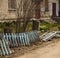 Broken blue fence front garden house in the city