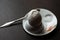 Broken boiled egg with spoon, stand and salt on dark