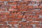 Broken brickwork with gray mortar