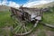 Broken, busted wagon in the grass at Bannack ghost town in Montana