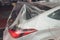 A broken car color silver, wrapped in a plastic coating. The car is covered with polyethylene after the accident. It is