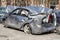 Broken car after a traffic accident in the parking lot of a repair station. Car body damage workshop outdoors. Sale of insurance