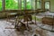 Broken chairs in premises of abandoned school in resettled village of Pogonnoye in Chernobyl exclusion zone, Belarus