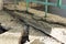 Broken concrete pavement. Broken blind area of an apartment building. Selective focus, shallow depth of field