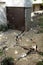 Broken concrete pavement. Broken blind area of an apartment building. Selective focus, shallow depth of field