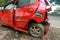 Broken crash red car on accident site. Accident and insurance